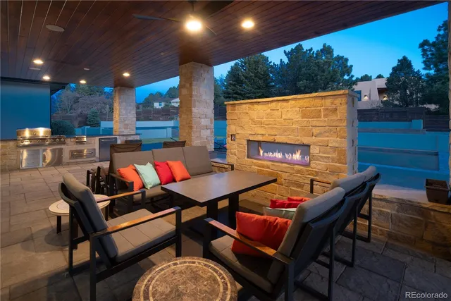 a outdoor sitting area with furniture and a fireplace