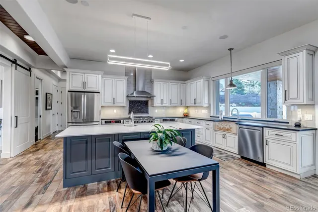 a kitchen with stainless steel appliances granite countertop a stove refrigerator sink and cabinets