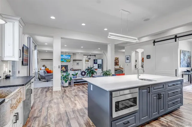 a kitchen with a sink stove and wooden cabinets