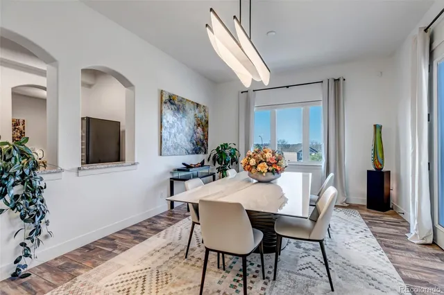 a view of a dining room with furniture and wooden floor