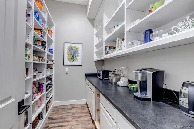 a kitchen with lots of clutter and stainless steel appliances