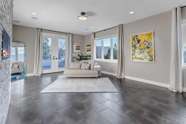 a living room with furniture and large windows