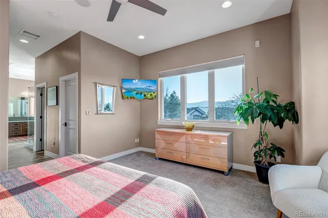 a bedroom with a bed and a potted plant