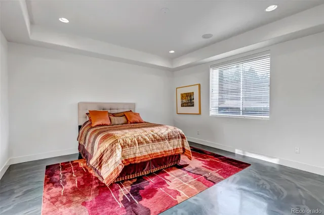 a bathroom with a granite countertop sink a toilet a mirror and shower