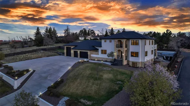 a view of a house with backyard and sitting area