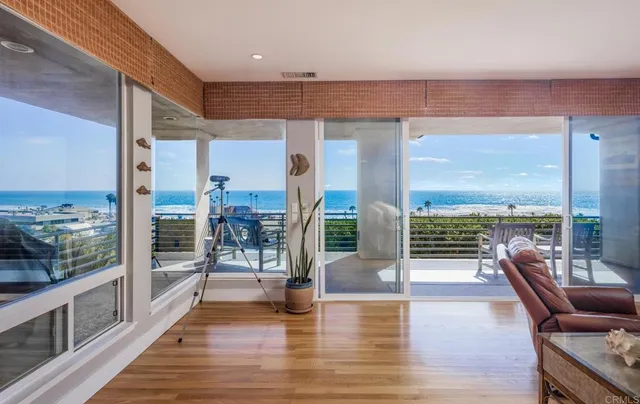 a lobby with furniture and floor to ceiling windows