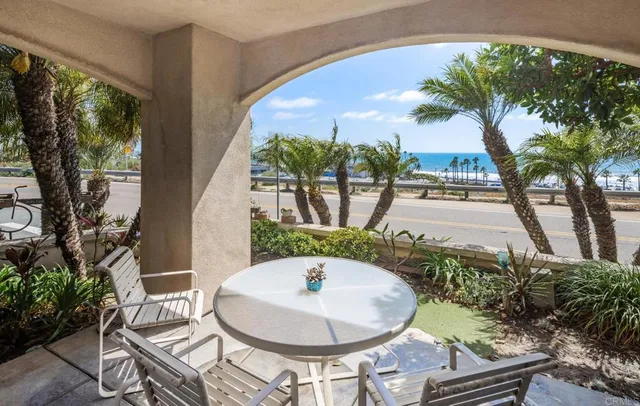 a backyard of a house with table and chairs potted plants with sky view