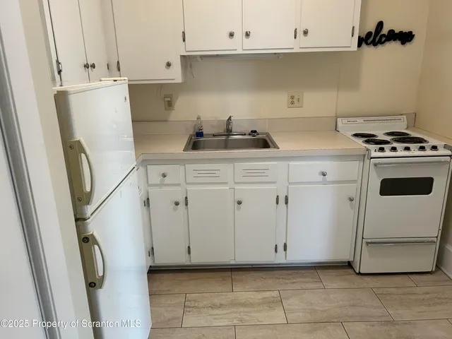 a view of a room with wooden floor and windows