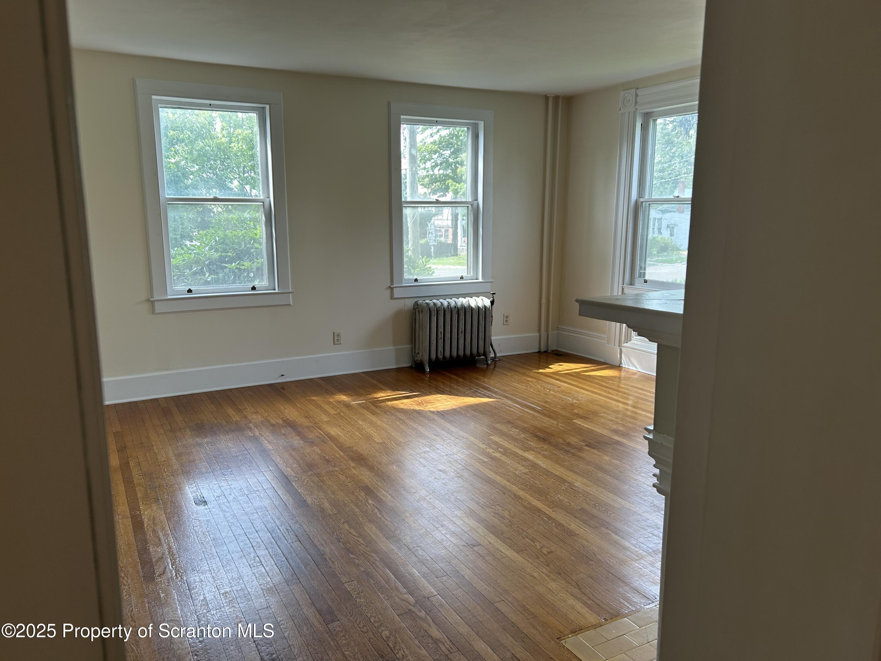 344 Church Street, Unit 1 Montrose, PA 18801 - Photo 4 of 10 a view of a room with wooden floor and windows