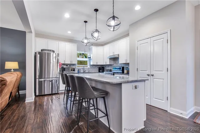 a view of a dining room with furniture and wooden floor
