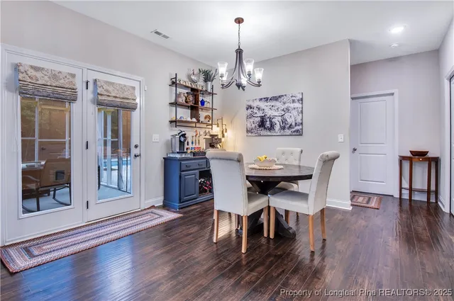 a spacious bedroom with a bed and a chandelier