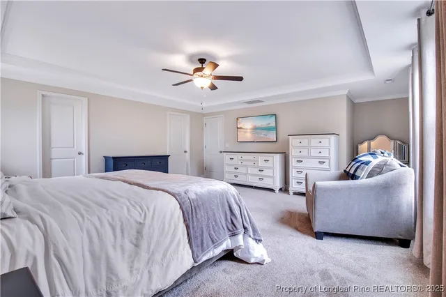 a view of walk in closet with clothes