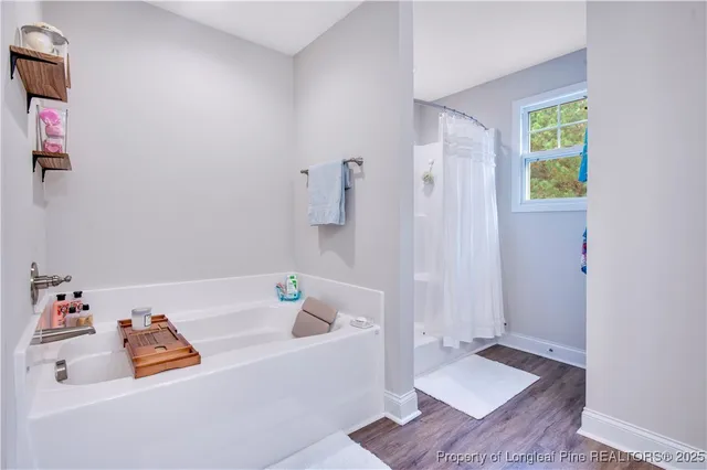 a bathroom with a granite countertop sink vanity mirror and toilet