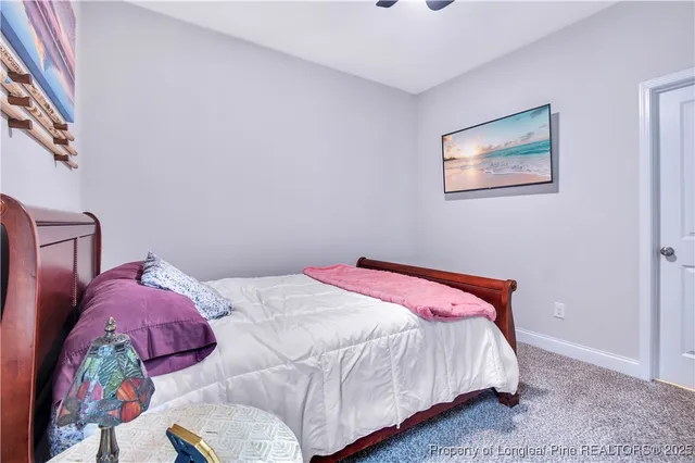 a bedroom with a bed a dresser and a window