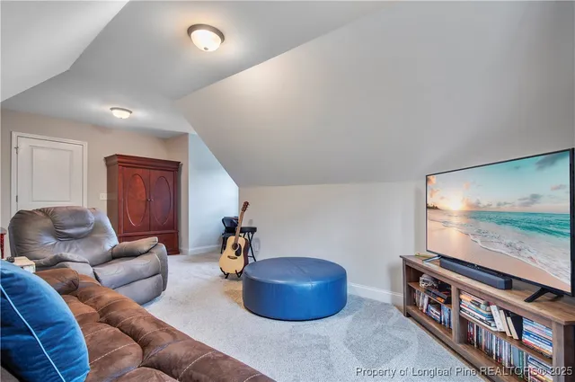 a bedroom with two bed and a lamp on dresser