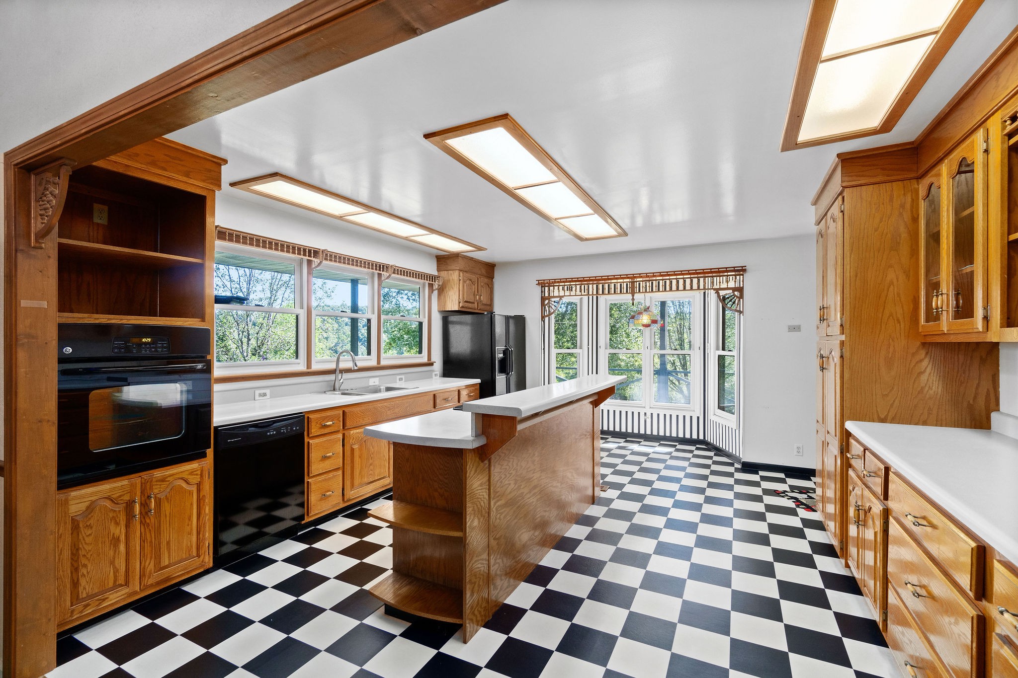 3250 Luther Ragan Road Palmyra, TN 37142 - Photo 12 of 44 a dining room with a black white checkered floor with a coffee table and chairs