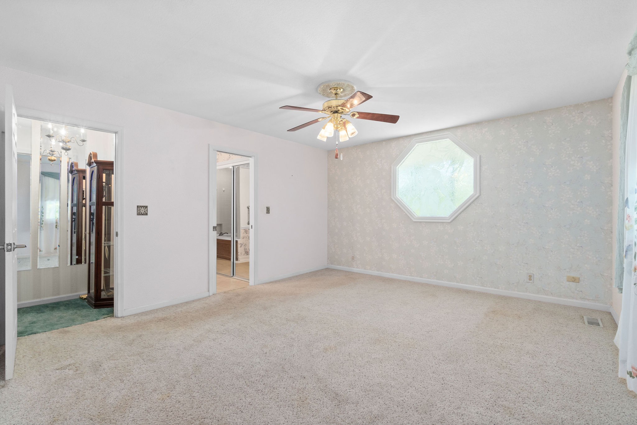 3250 Luther Ragan Road Palmyra, TN 37142 - Photo 18 of 44 an empty room with chandelier fan and windows