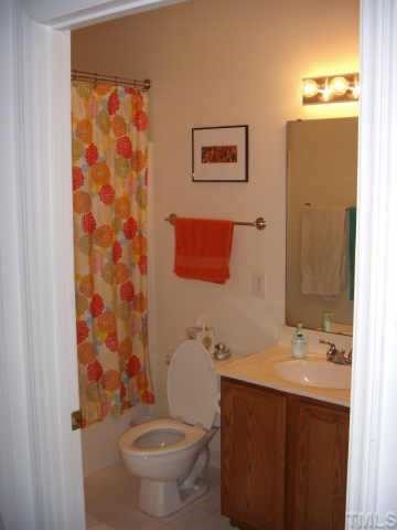720 North Person Street, Unit 105 Raleigh, NC 27604 - Photo 5 of 8 a bathroom with a sink toilet and shower
