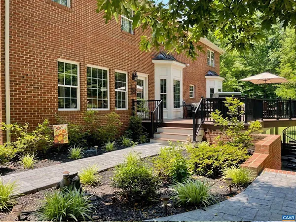 a large kitchen with granite countertop a sink and dishwasher a stove top oven with wooden floor