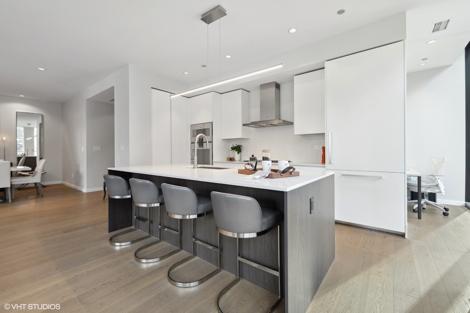 56 West Huron Street, Unit 6 Chicago, IL 60654 - Photo 11 of 32 a kitchen with a sink cabinets and dining table chair