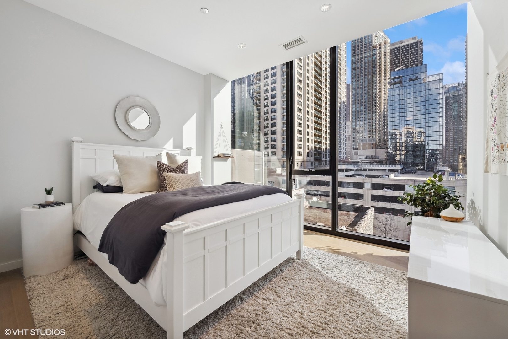 56 West Huron Street, Unit 6 Chicago, IL 60654 - Photo 19 of 32 a bedroom with a bed and a large window with balcony view