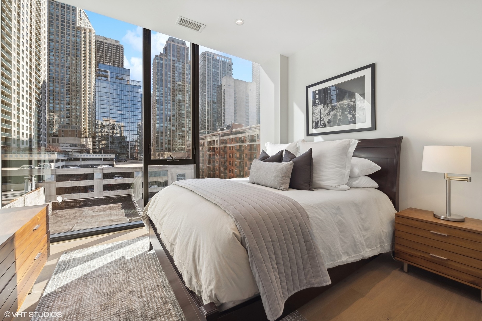 56 West Huron Street, Unit 6 Chicago, IL 60654 - Photo 25 of 32 a bed room with a bed and a night stand