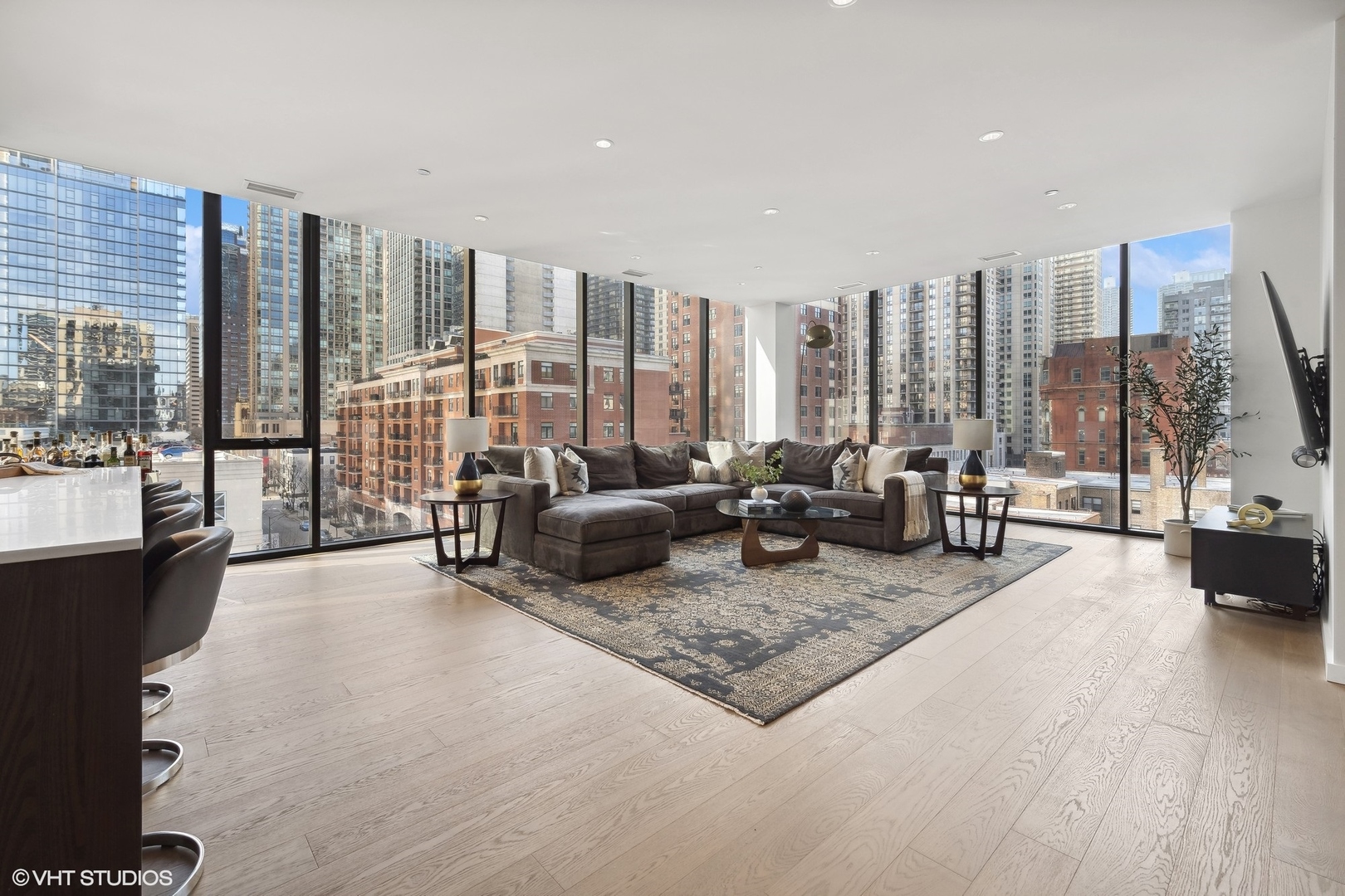 56 West Huron Street, Unit 6 Chicago, IL 60654 - Photo 3 of 32 a living room with furniture large windows and a wooden floor