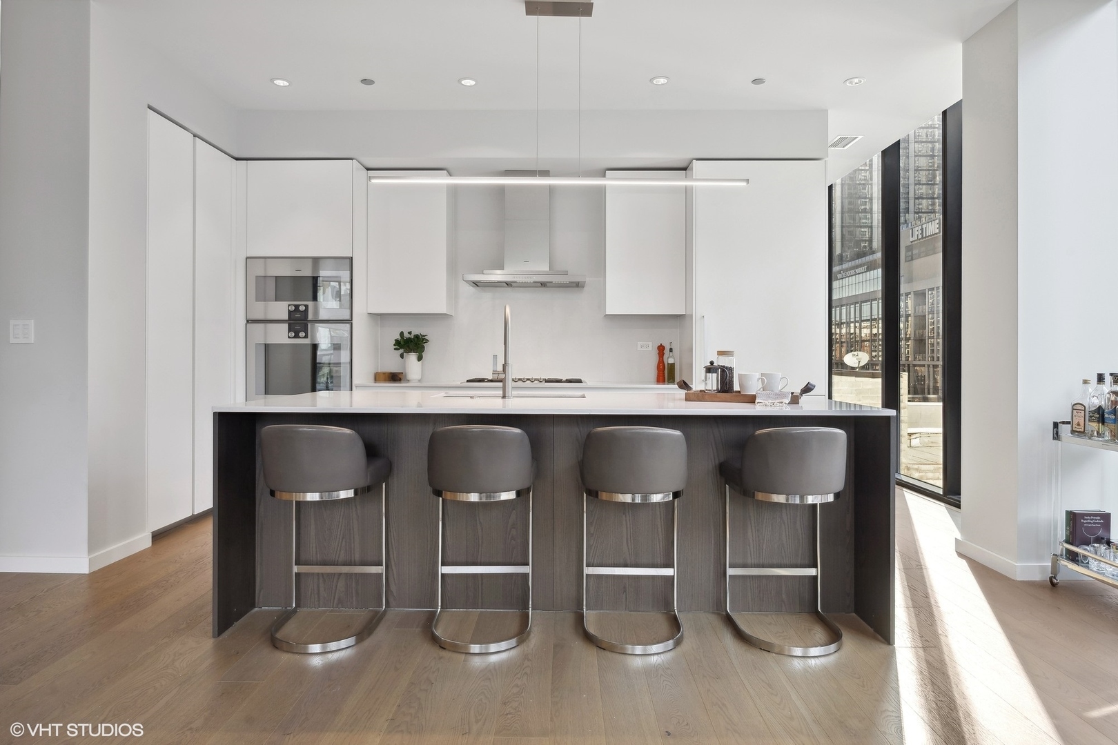 56 West Huron Street, Unit 6 Chicago, IL 60654 - Photo 6 of 32 a kitchen with stainless steel appliances granite countertop a sink and a refrigerator