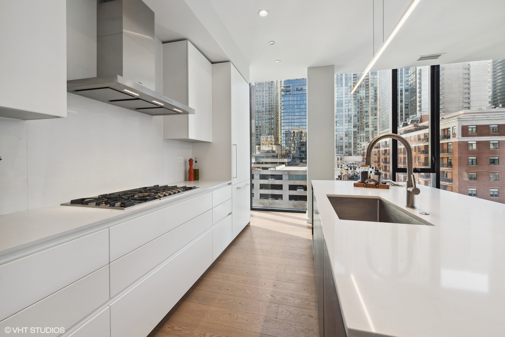 56 West Huron Street, Unit 6 Chicago, IL 60654 - Photo 8 of 32 a large kitchen with stainless steel appliances a sink a stove and cabinets