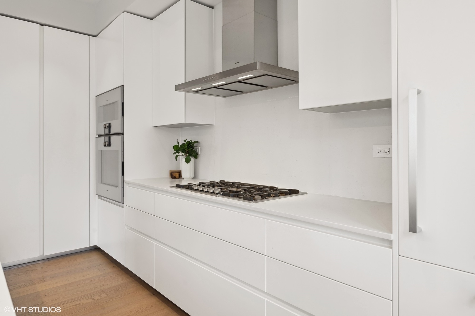 56 West Huron Street, Unit 6 Chicago, IL 60654 - Photo 10 of 32 a kitchen with white cabinets and appliances