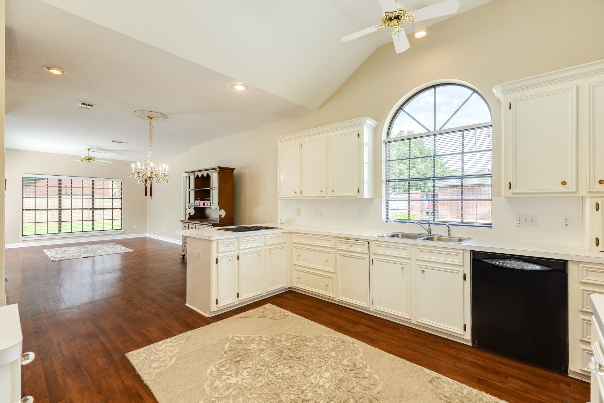 704 Walnut Street Lake Jackson, TX 77566 - Photo 11 of 27 a large kitchen with stainless steel appliances granite countertop a stove top oven a sink dishwasher and white cabinets with wooden floor