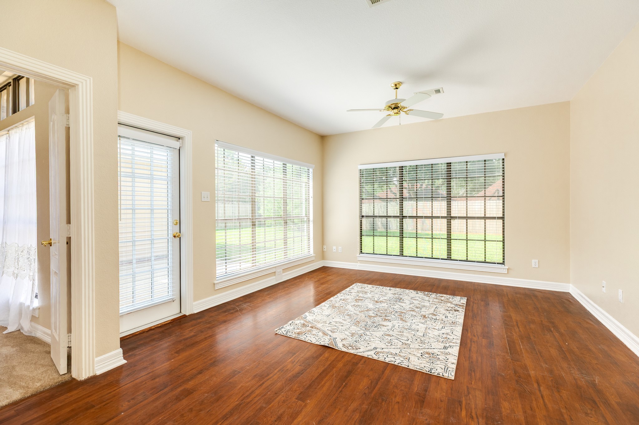 704 Walnut Street Lake Jackson, TX 77566 - Photo 14 of 27 an empty room with wooden floor and windows
