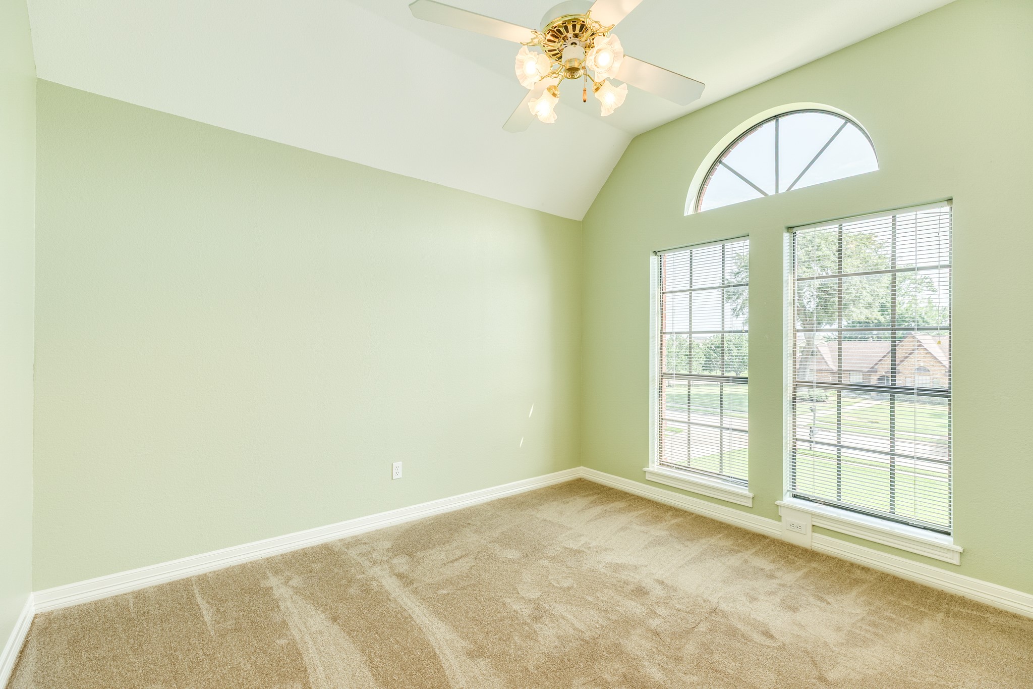 704 Walnut Street Lake Jackson, TX 77566 - Photo 22 of 27 an empty room with a chandelier fan and windows