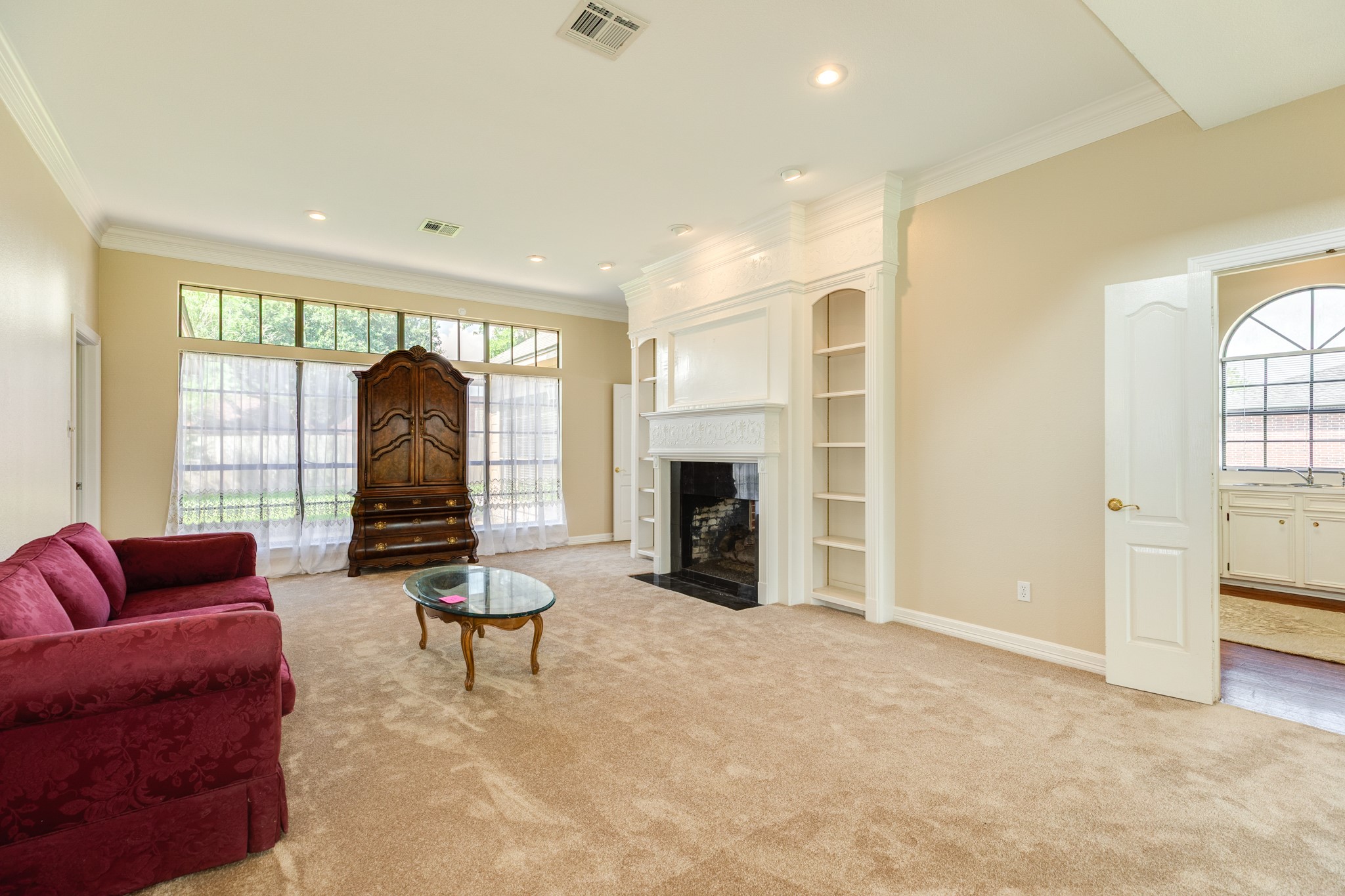 704 Walnut Street Lake Jackson, TX 77566 - Photo 7 of 27 a living room with furniture a fireplace and a large window