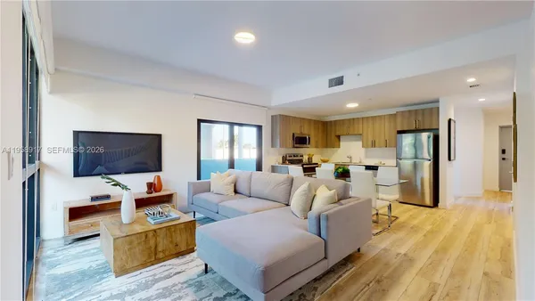a living room with furniture and a flat screen tv
