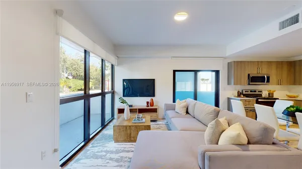 a living room with furniture and a flat screen tv