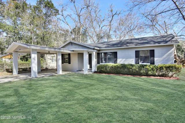 a front view of a house with a garden