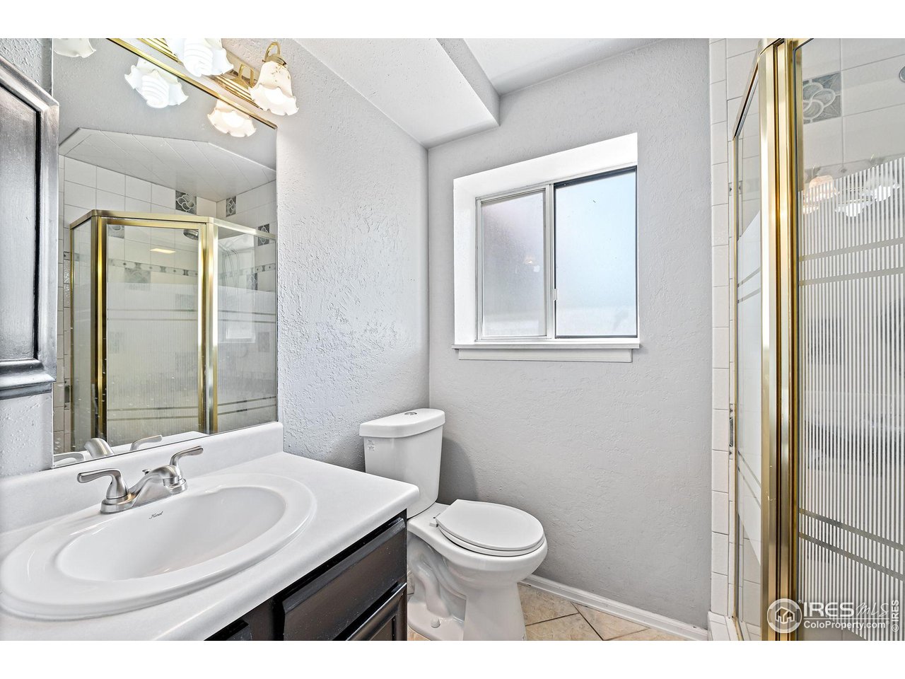 1305 Inverness Drive Lafayette, CO 80026 - Photo 11 of 41 a bathroom with a toilet a sink and mirror
