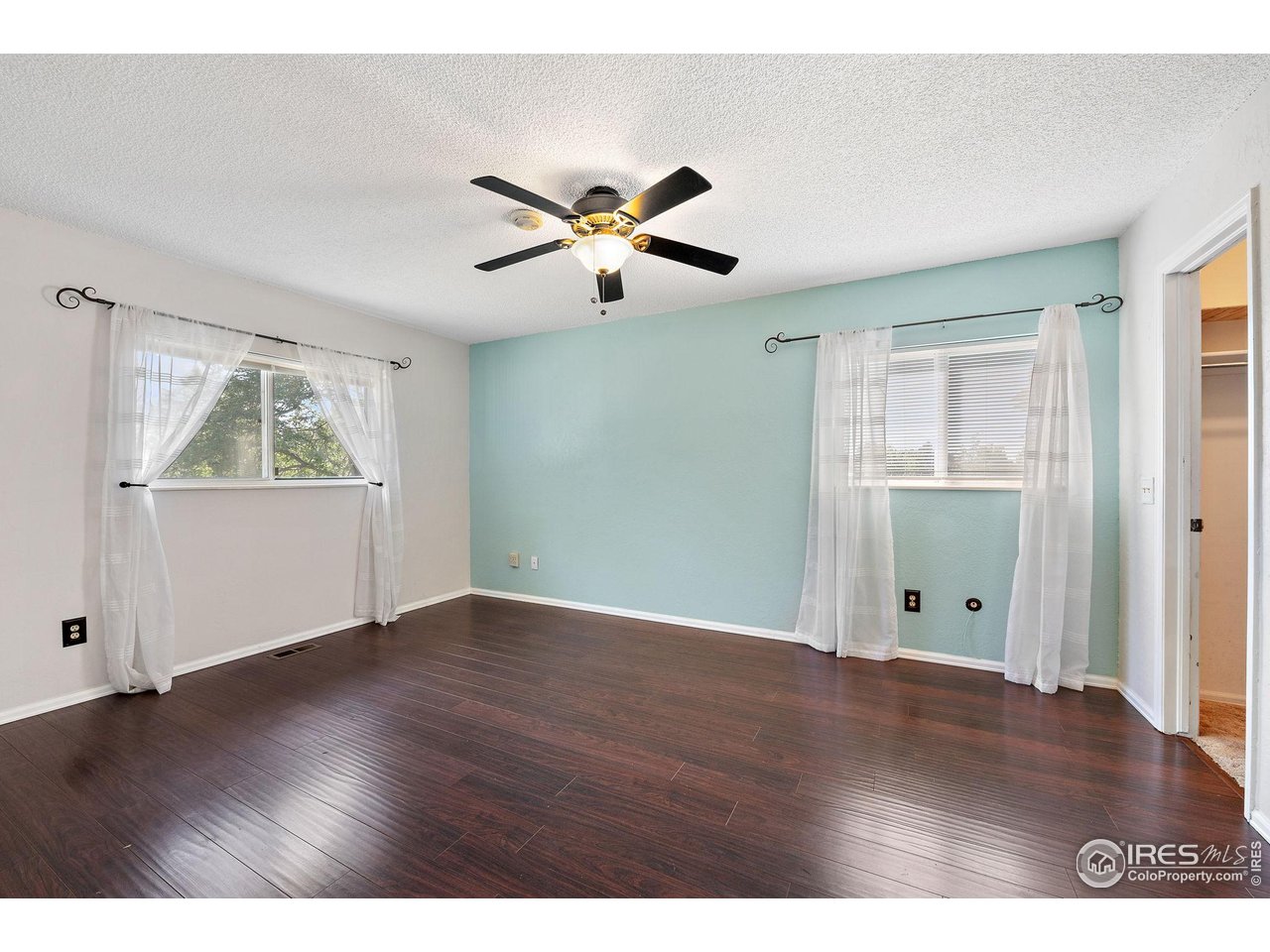 1305 Inverness Drive Lafayette, CO 80026 - Photo 13 of 41 a view of an empty room with a window and wooden floor