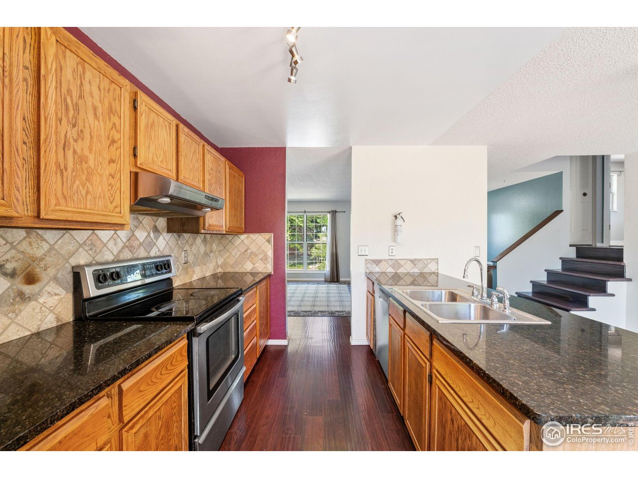 1305 Inverness Drive Lafayette, CO 80026 - Photo 17 of 41 a kitchen with stainless steel appliances granite countertop a sink stove and cabinets