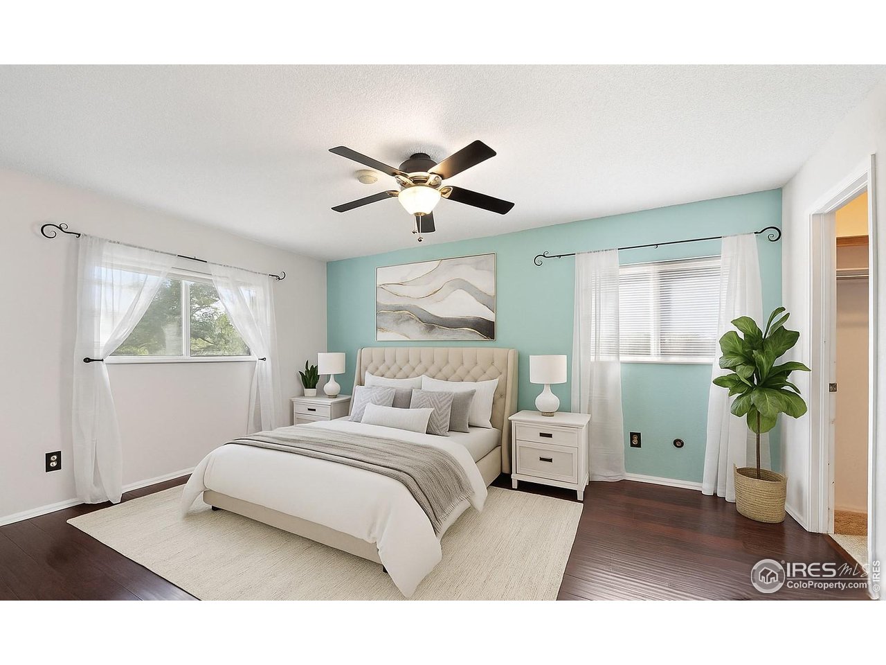 1305 Inverness Drive Lafayette, CO 80026 - Photo 23 of 41 a bedroom with a bed and a potted plant