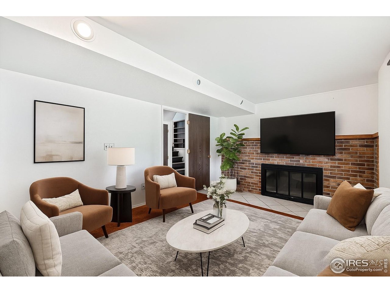 1305 Inverness Drive Lafayette, CO 80026 - Photo 24 of 41 a living room with furniture flat screen tv and a fireplace
