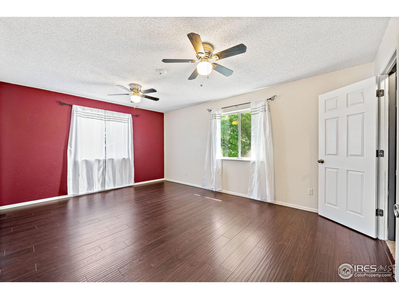 1305 Inverness Drive Lafayette, CO 80026 - Photo 10 of 41 a view of an empty room with wooden floor and a window