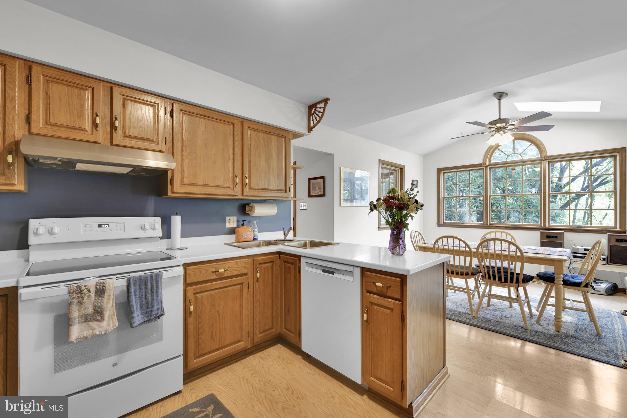 400 Reitnour Road Spring City, PA 19475 - Photo 36 of 52 a kitchen with a stove a sink a dining table and chairs