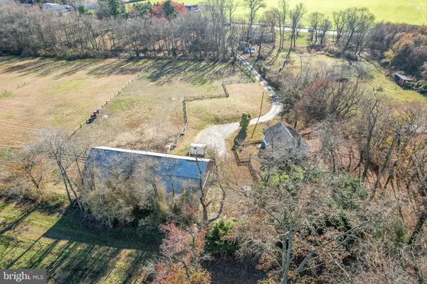 a view of a house with a yard and large tree