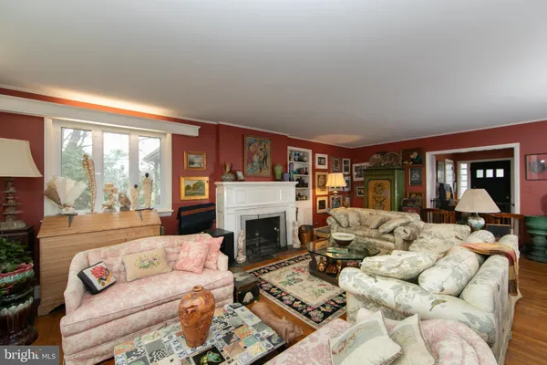 a view of a livingroom with furniture hardwood floor and a floor to ceiling window