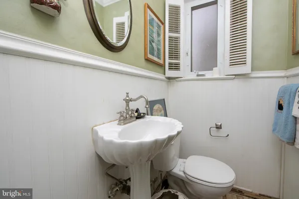 a bedroom with two beds and painting on the wall