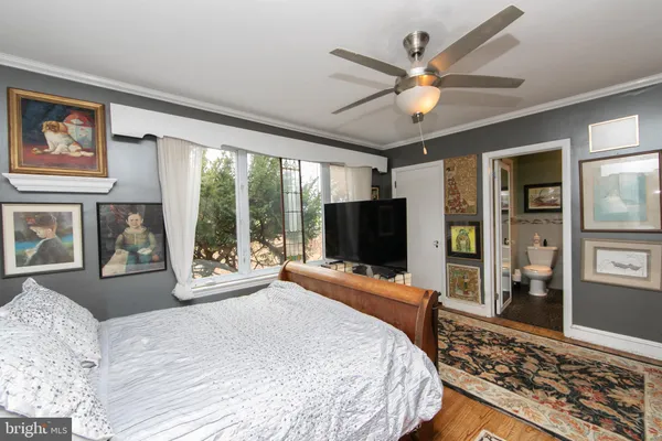a bed room with a bed cabinets and a window