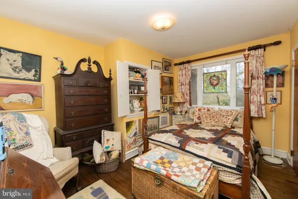 a living room with furniture a flat screen tv and a window