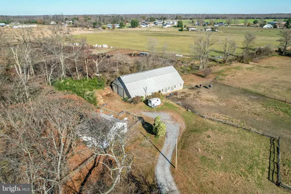 an aerial view of a house with a yard and trees